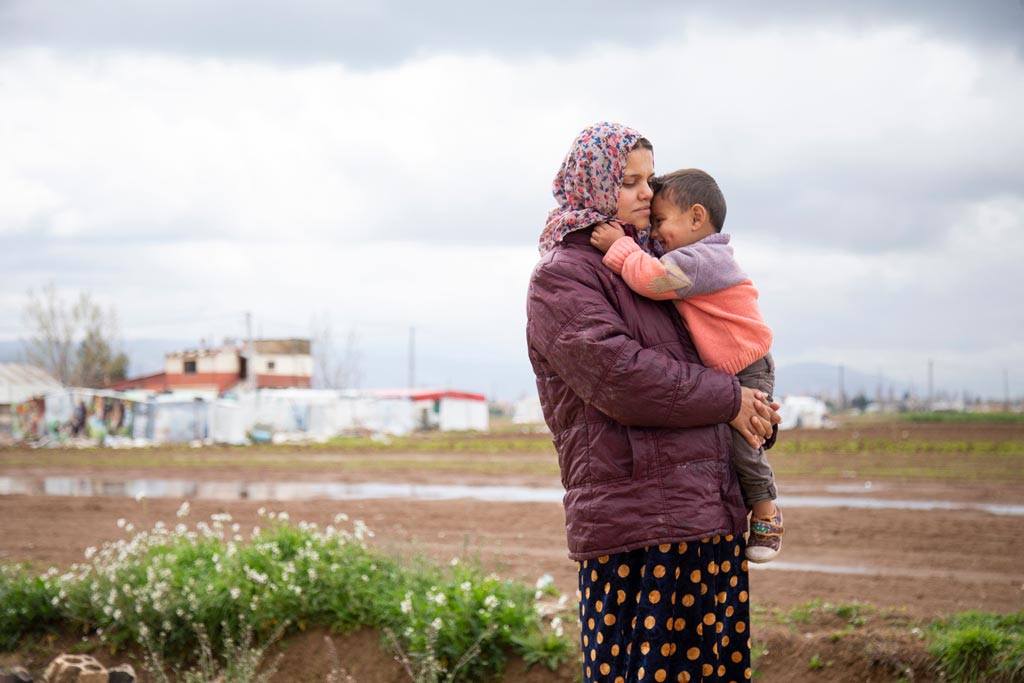 Randa Al Abed, 23, pictured holding her youngest son, Jasem Al Mohammad, Bekaa Valley, Lebanon, April 2019. Elie Gardner/RI
