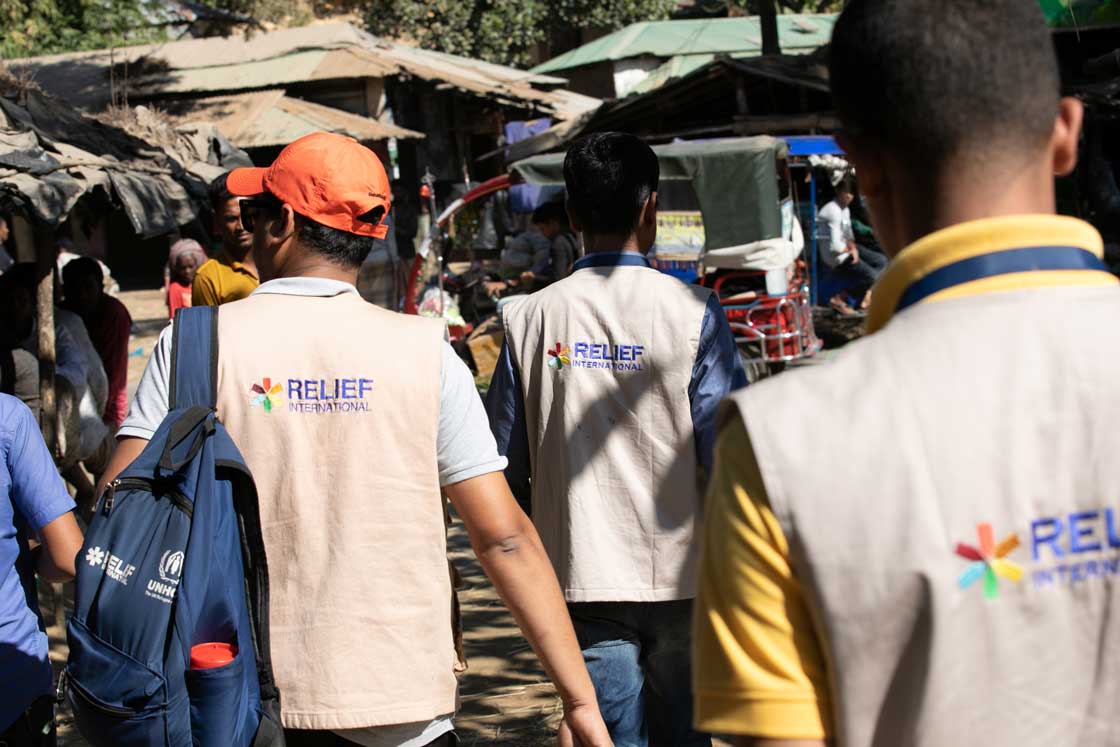 Teams walk through Bangladesh's crowded Kutupalong refugee camp to to reach remote areas of the camp. Rachel Elkind/RI