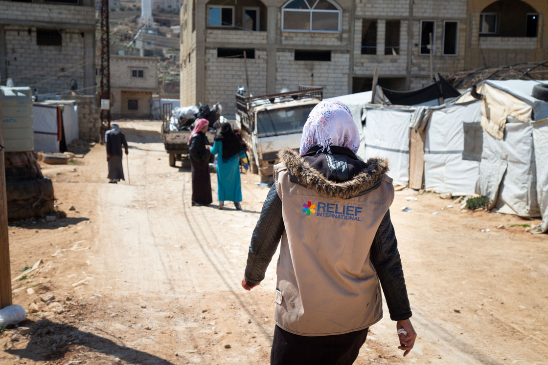 Iman walks through the informal tent settlement where she lives in Arsal, Lebanon. Elie Gardner/RI