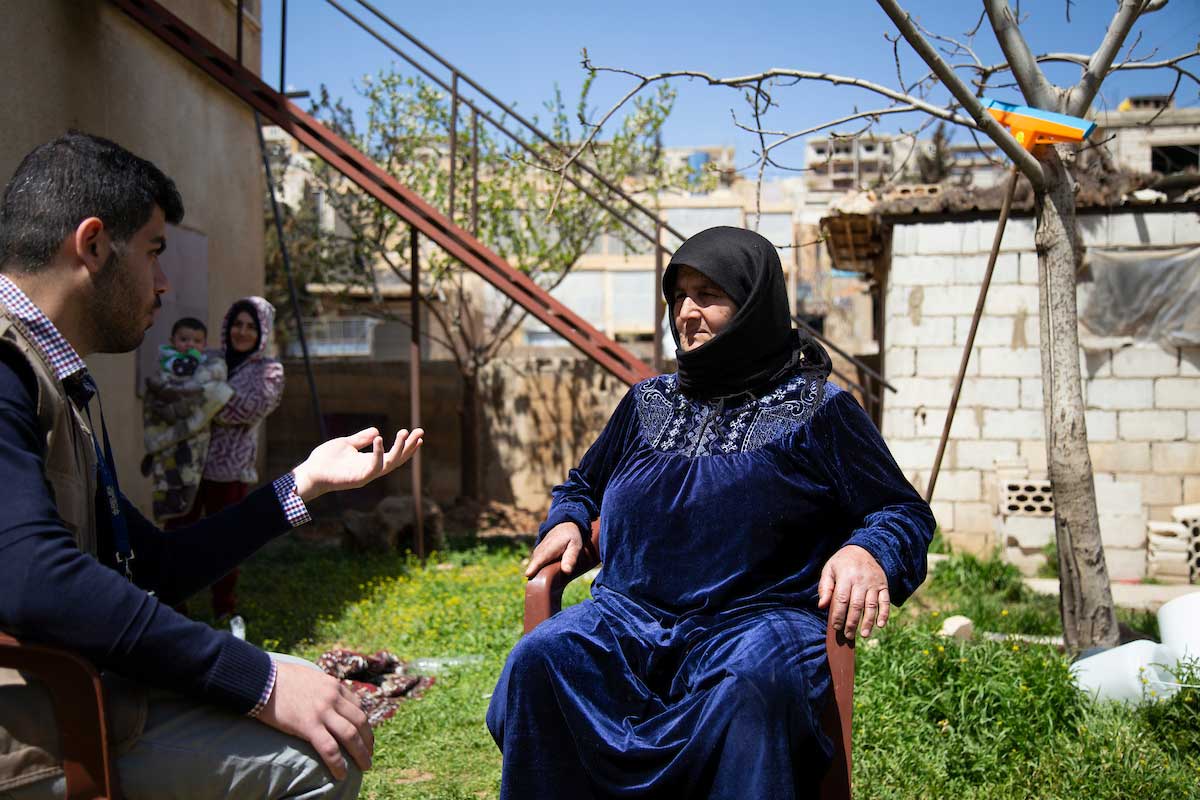 Relief International social worker Mazen Al Jabali talks with Mariam at her home in Arsal during a weekly counselling session. Elie Gardner