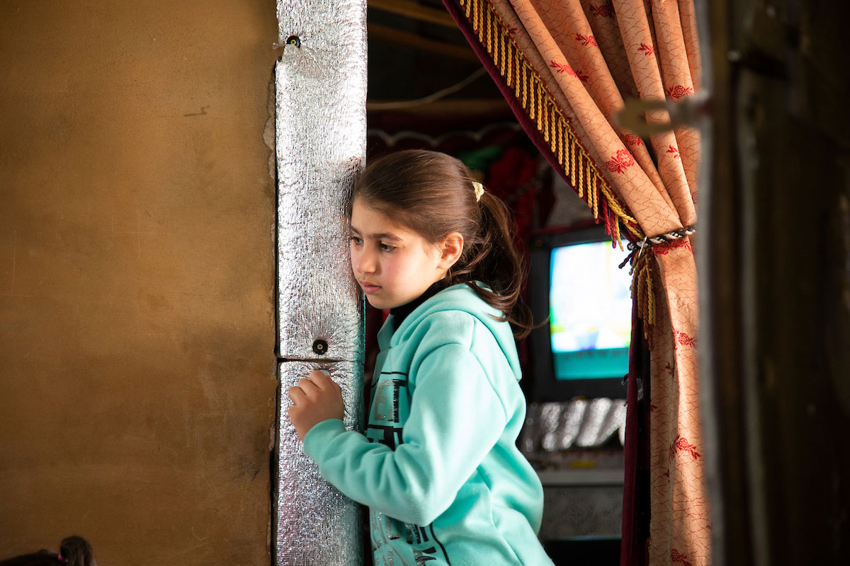 Asmaa’s daughter peers around the corner during her mom’s psychosocial support session. Elie Gardner/RI