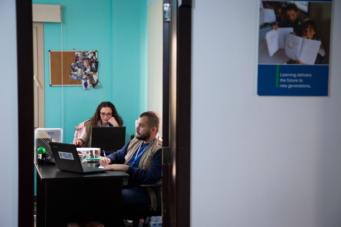 Giselle Hamzo and Georges Kassouf, both Cash for Education Field Assistants, photographed at Relief International's Bekaa office in Lebanon. Elie Gardner/RI