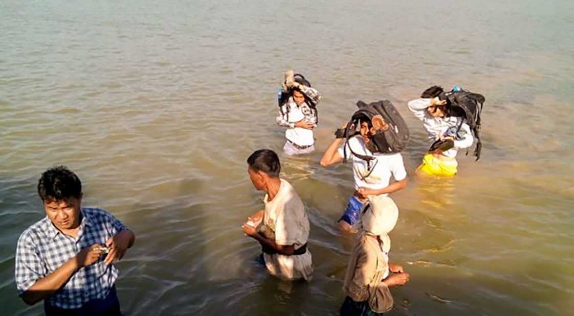 Our health teams wading through a river to reach remote communities in Myebon, Rakine State.