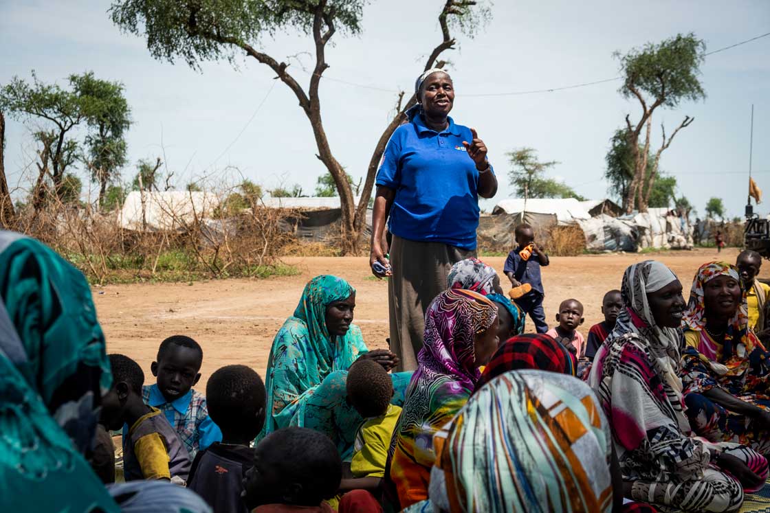 Care groups, like the one pictured here in Batil refugee camp, South Sudan, meet every two weeks for about an hour. Mama Judith, senior BCC officer, says a few words to the group at the close of their session. Elie Gardner/RI