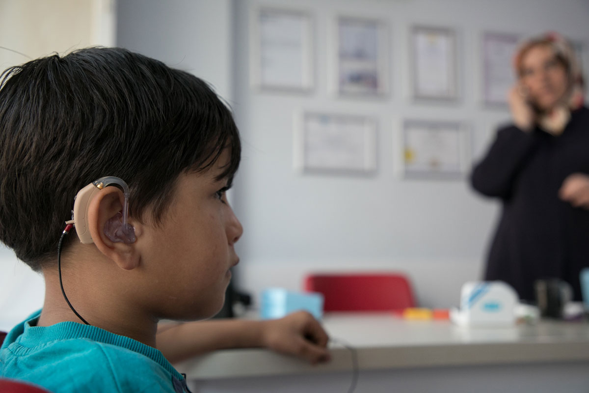 A young Syrian refugee uses a hearing aid for the first time. Rachel Elkind/RI