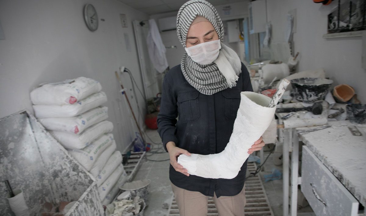 Rahaf is a technician who makes prosthetic limbs at Relief International's clinic. Rachel Elkind/RI