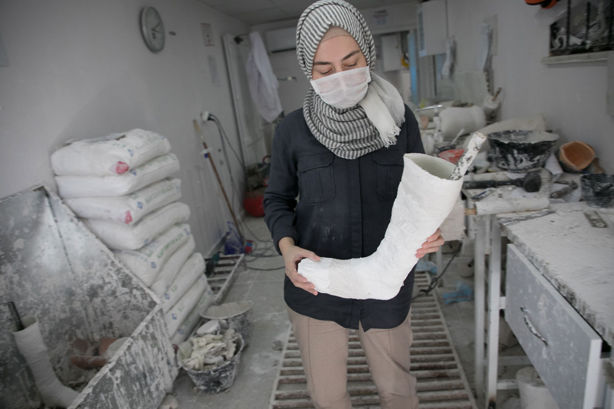 Rahaf is a technician who makes prosthetic limbs at Relief International's clinic. Rachel Elkind/RI