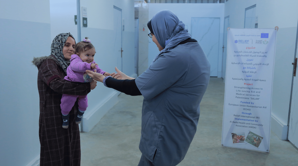 Dr. Wisal Abu Laban and a young patient..